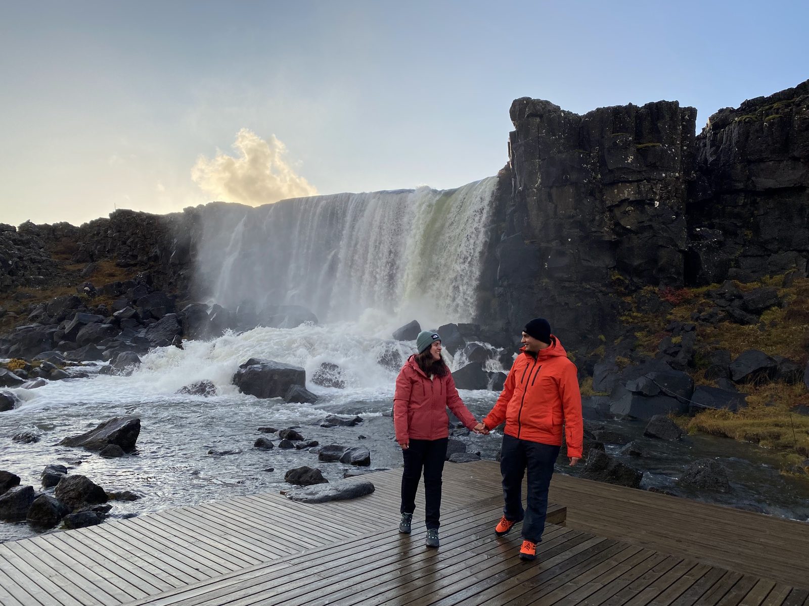 Pareja en Þingvellir junto a una cascada, Islandia